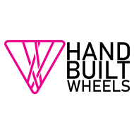 Upside down pink triangle with spokes crossing it, representing the Hand Built Wheels company logo with text saying hand built wheels